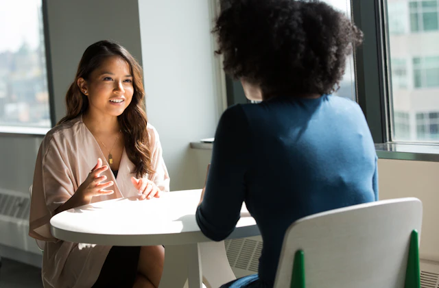 Two colleagues in a conversation at an office table